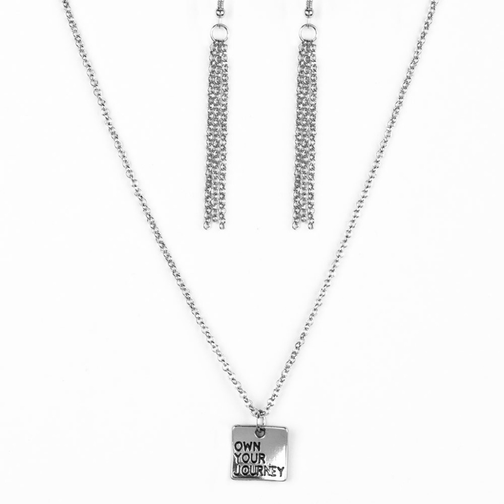 Silver "Own Your Journey" necklace.